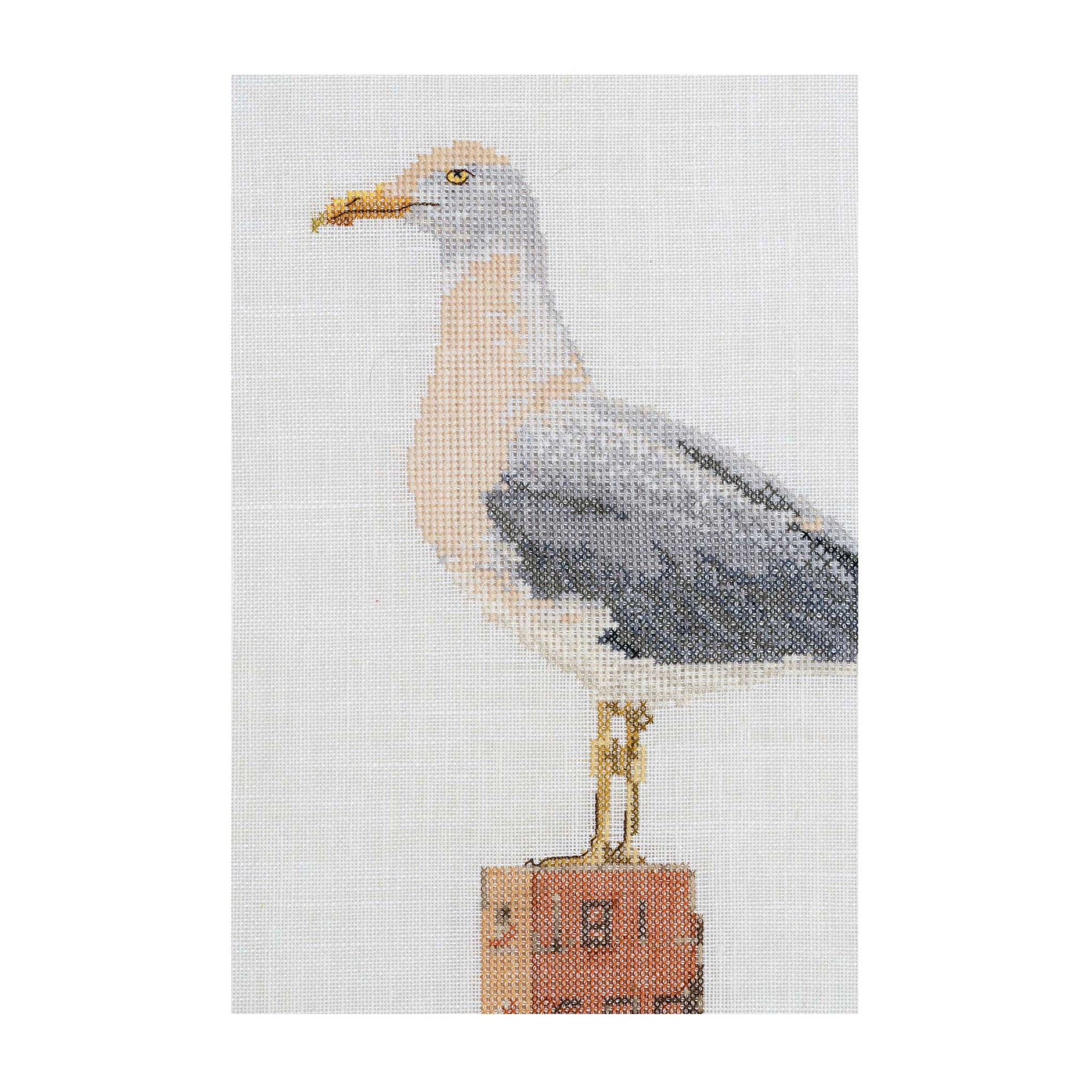 Cross-stitched seagull seaside close up