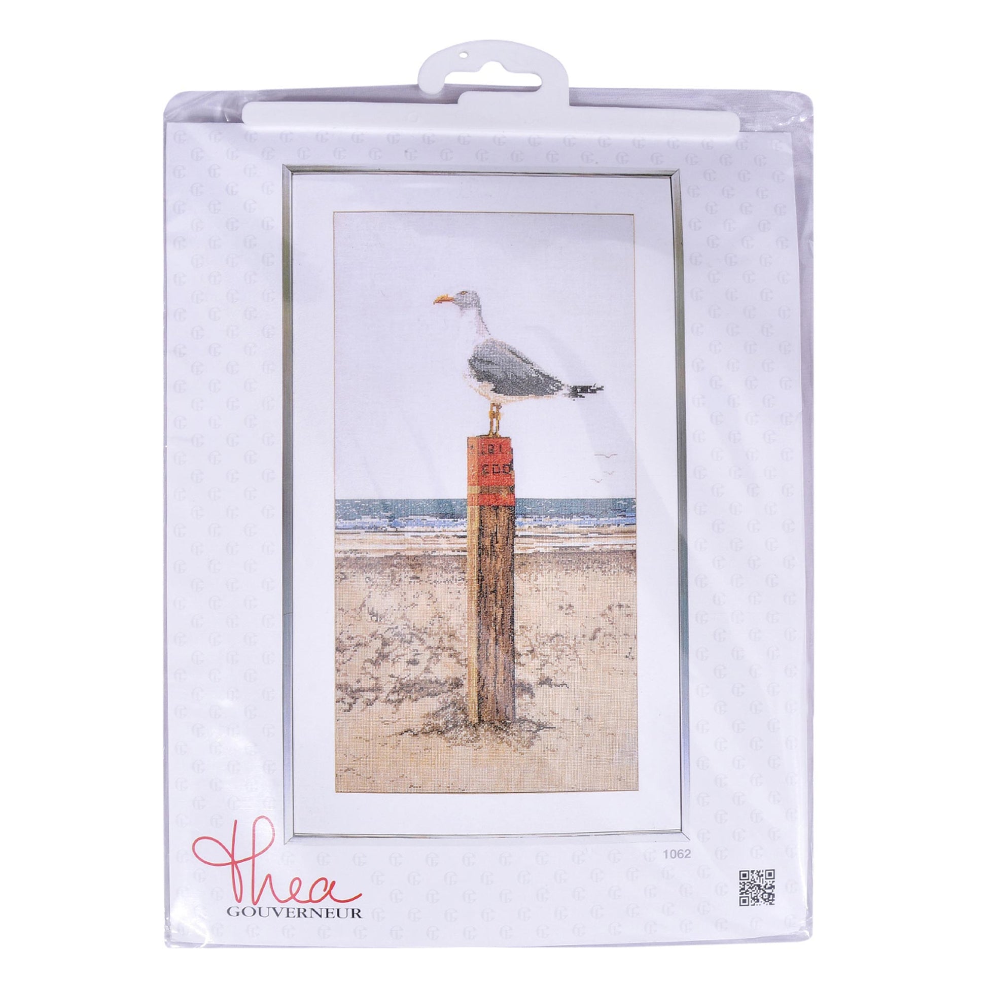 Packaged cross stitch of a seagull on a post with a beach scene, featuring the designer name 'Thea Gouverneur'.
