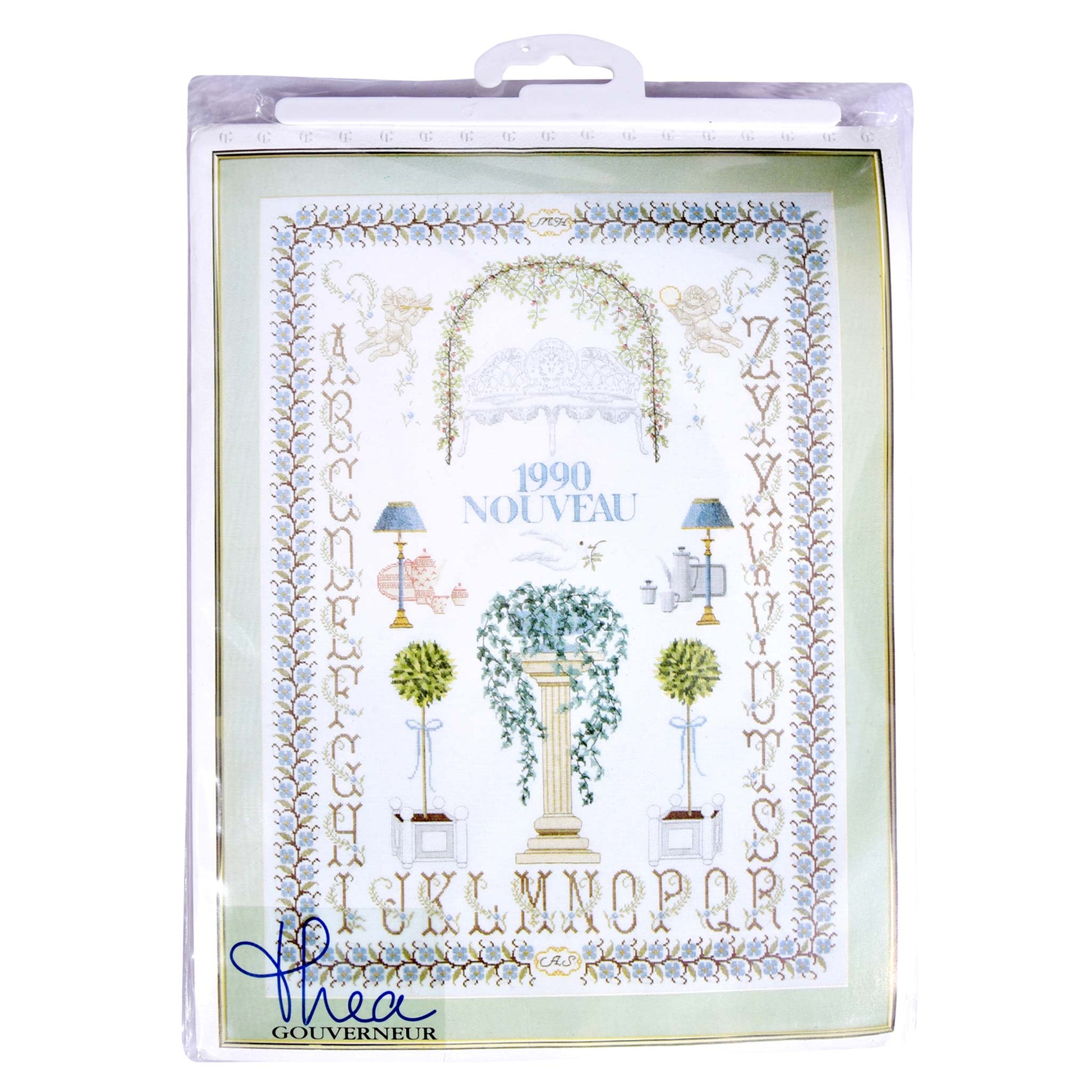 Decorative embroidery packaging with floral design and alphabet sample, featuring the brand 'Thea Gouverneur'.