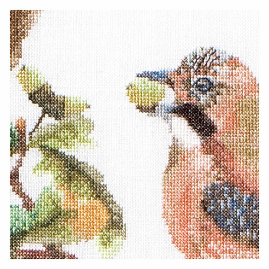 Cross-stitched close up of a bird and a branch on a white background