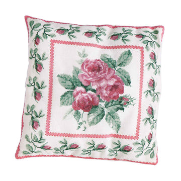 Decorative pillow with floral embroidery on a white background