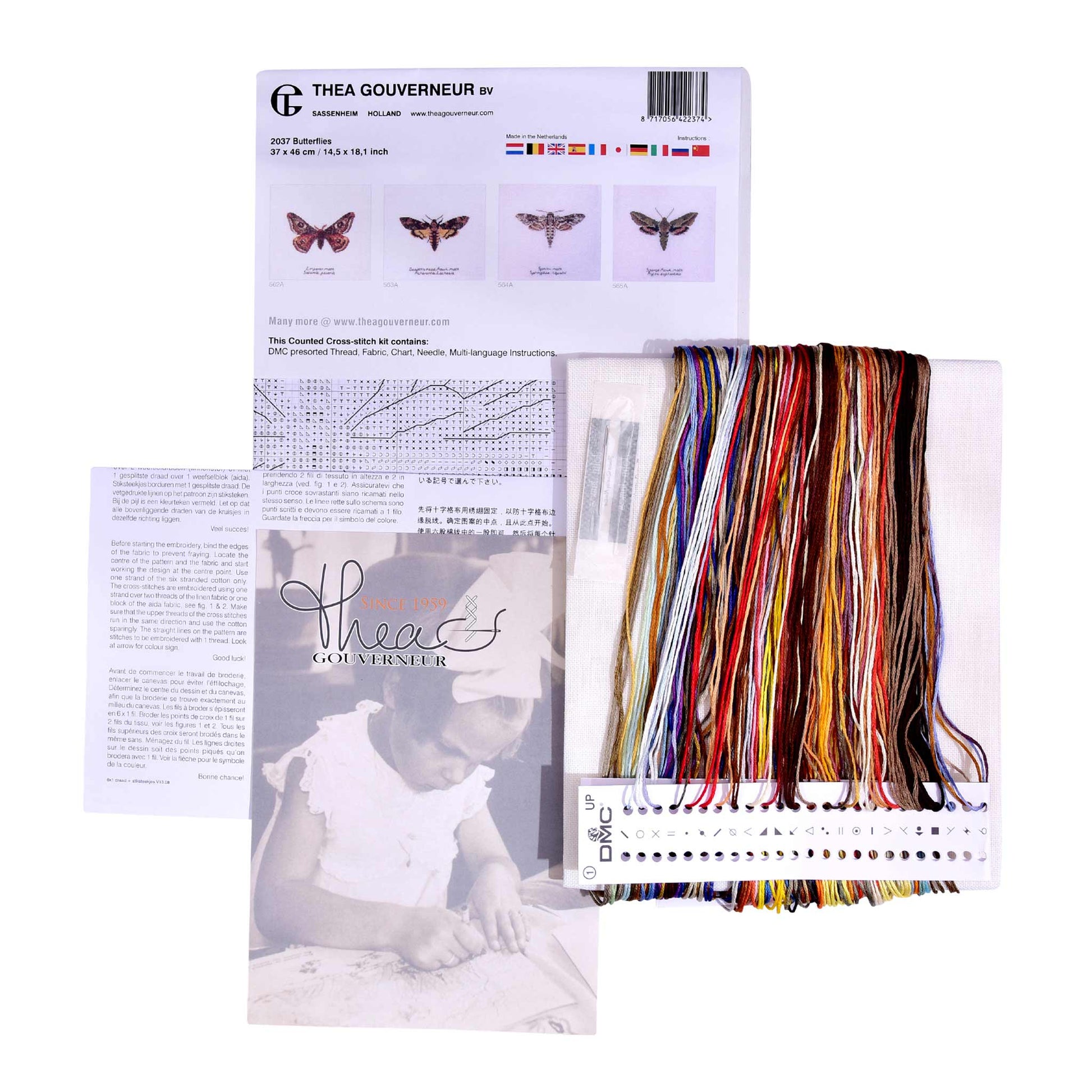 Cross stitch kit with colorful threads and pattern guide on a white background