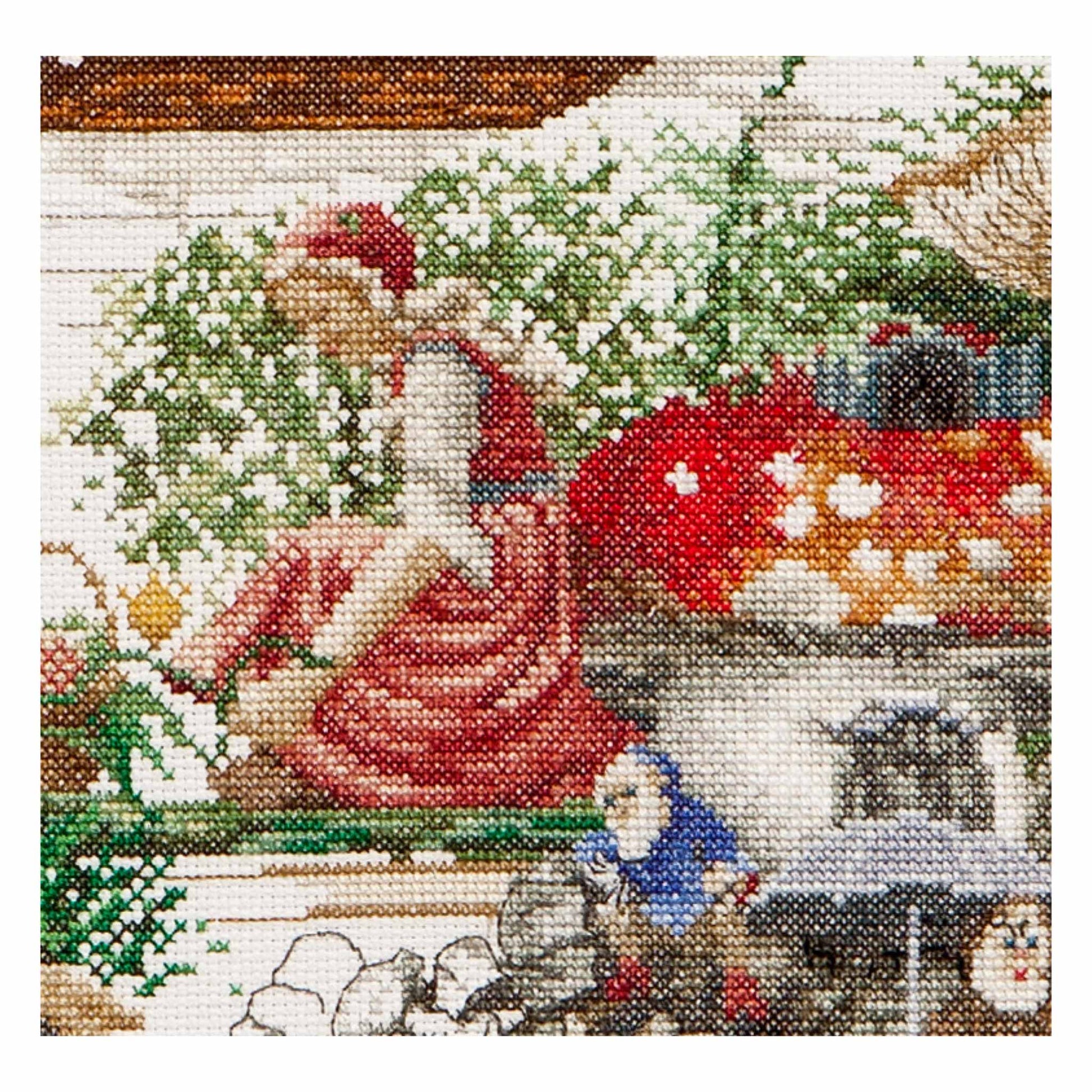Cross stitch scene with fairy and two gnomes near a mushroom house, Efteling park in the Netherlands