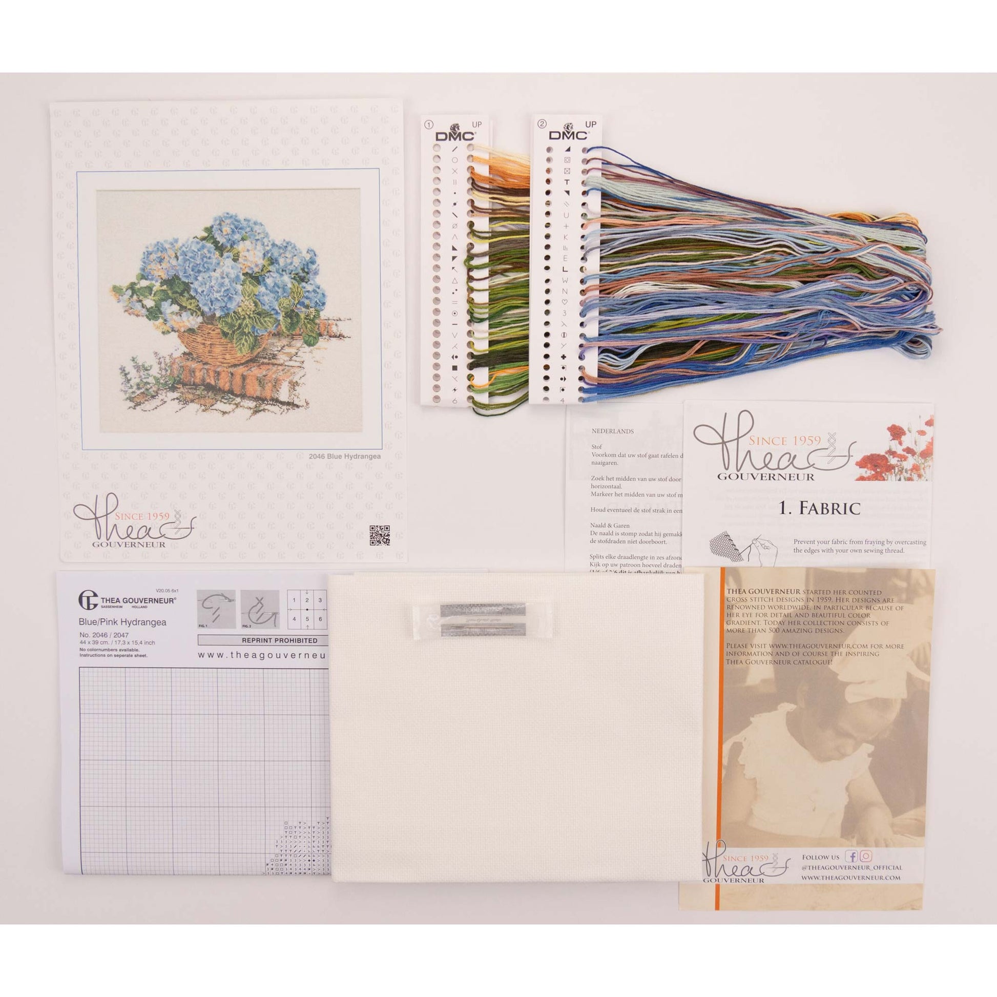 Embroidery kit with pattern and chart, needlework fabric, and DMC floss threads on a white background