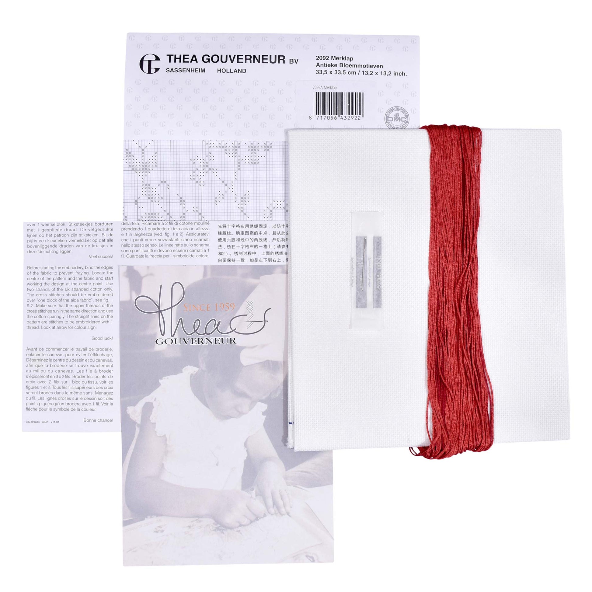 Embroidery kit with pattern and chart, needlework fabric, and threads on a white background