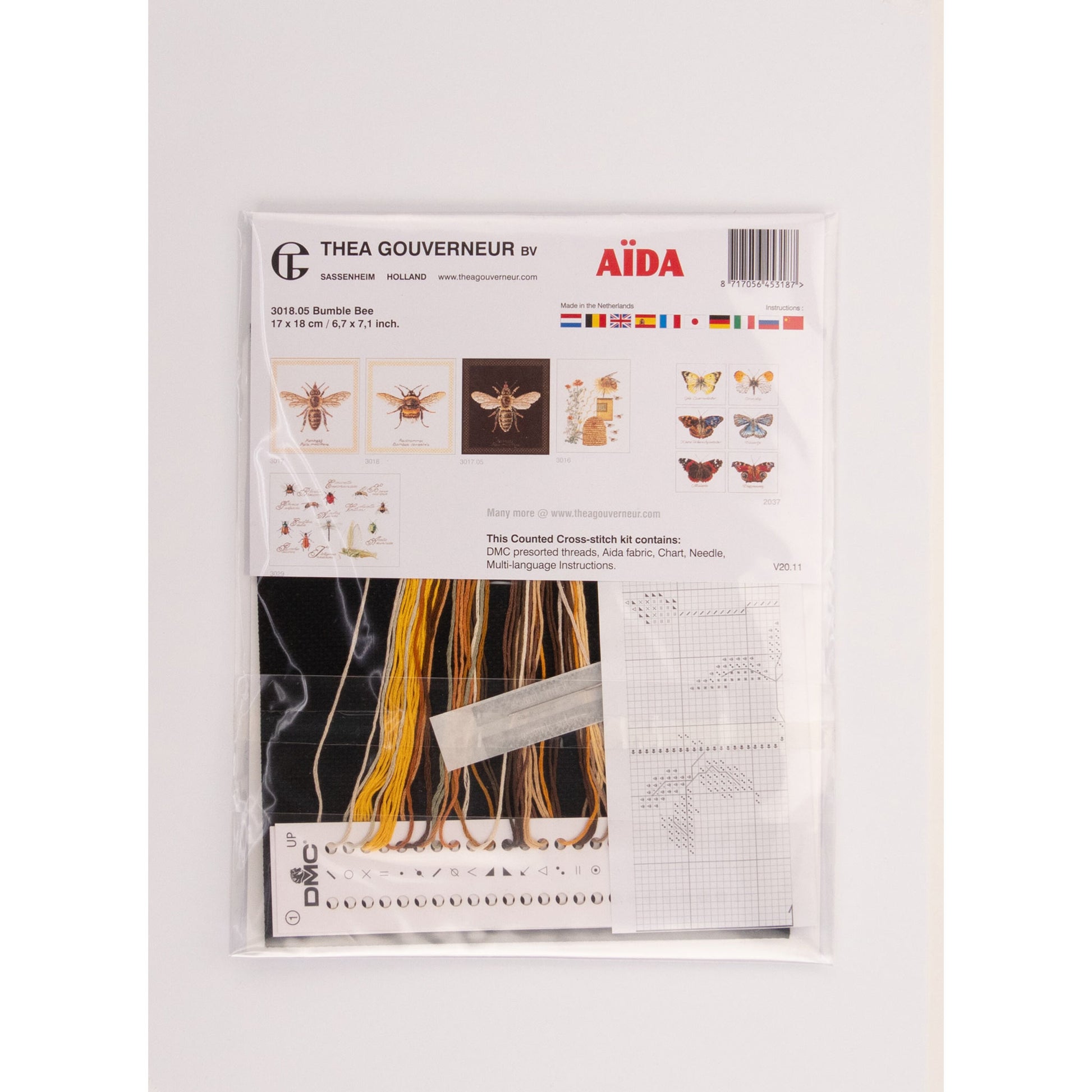 Embroidery kit packaging with patterns and materials on a white background