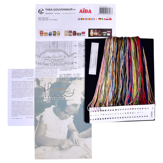 Embroidery kit with pattern and chart, needlework fabric, and threads on the floss organizer.