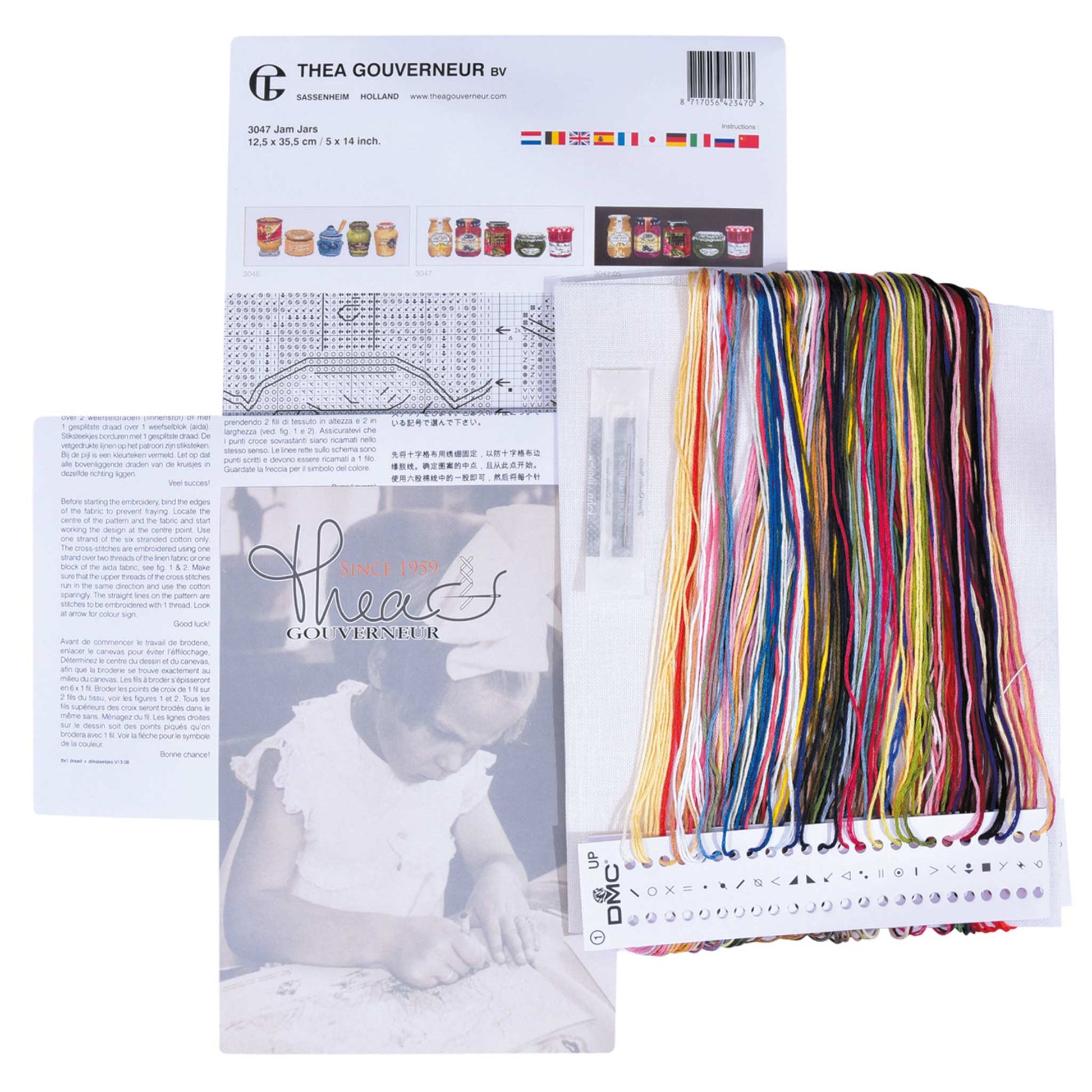 Embroidery kit with pattern and chart, needlework fabric, and threads on a white background