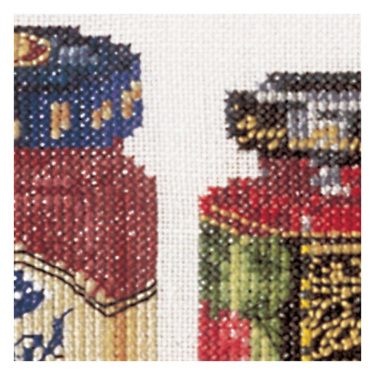 Close-up of a cross-stitched design featuring a jam pots