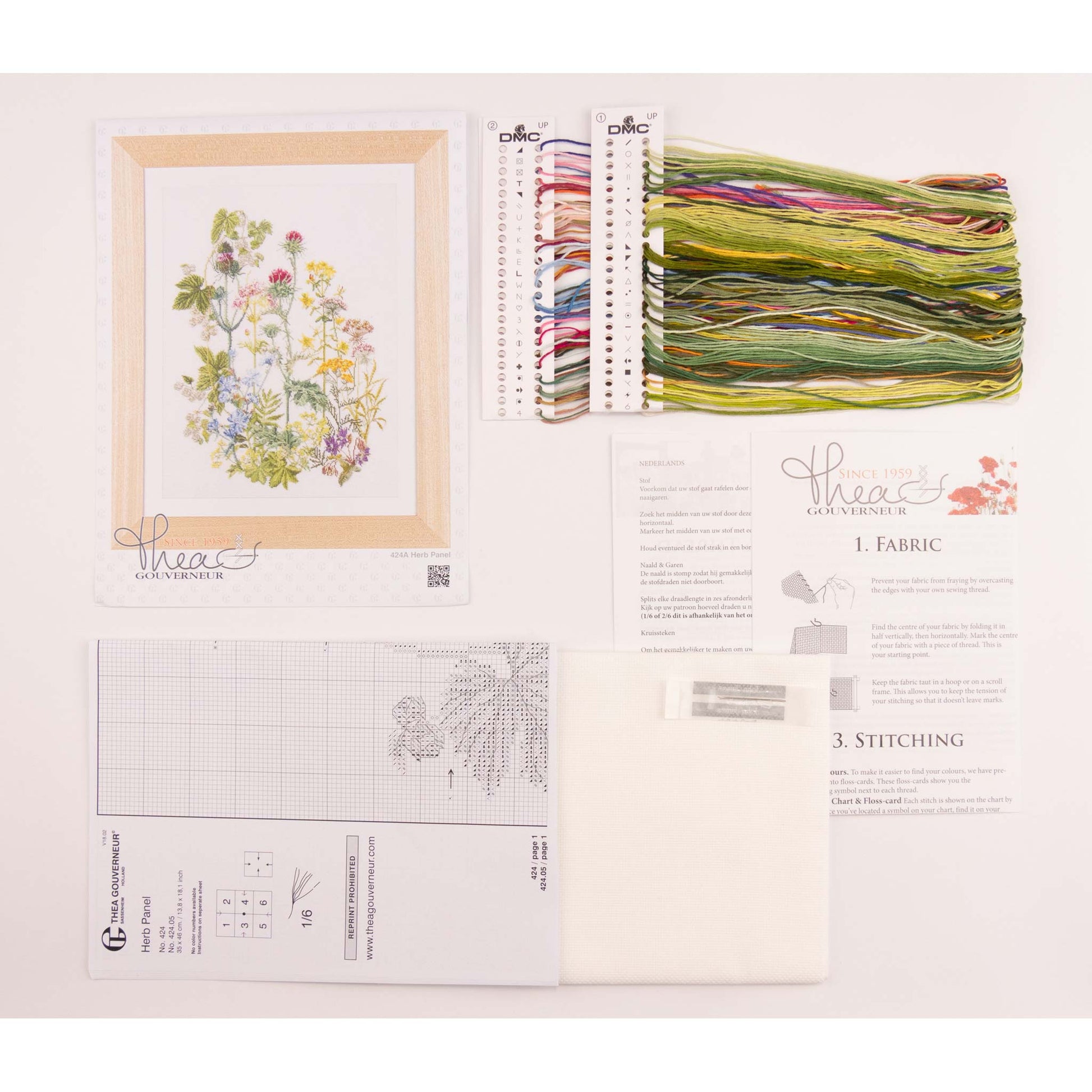 Embroidery kit with needlework fabric, threads, and design chart on a white background
