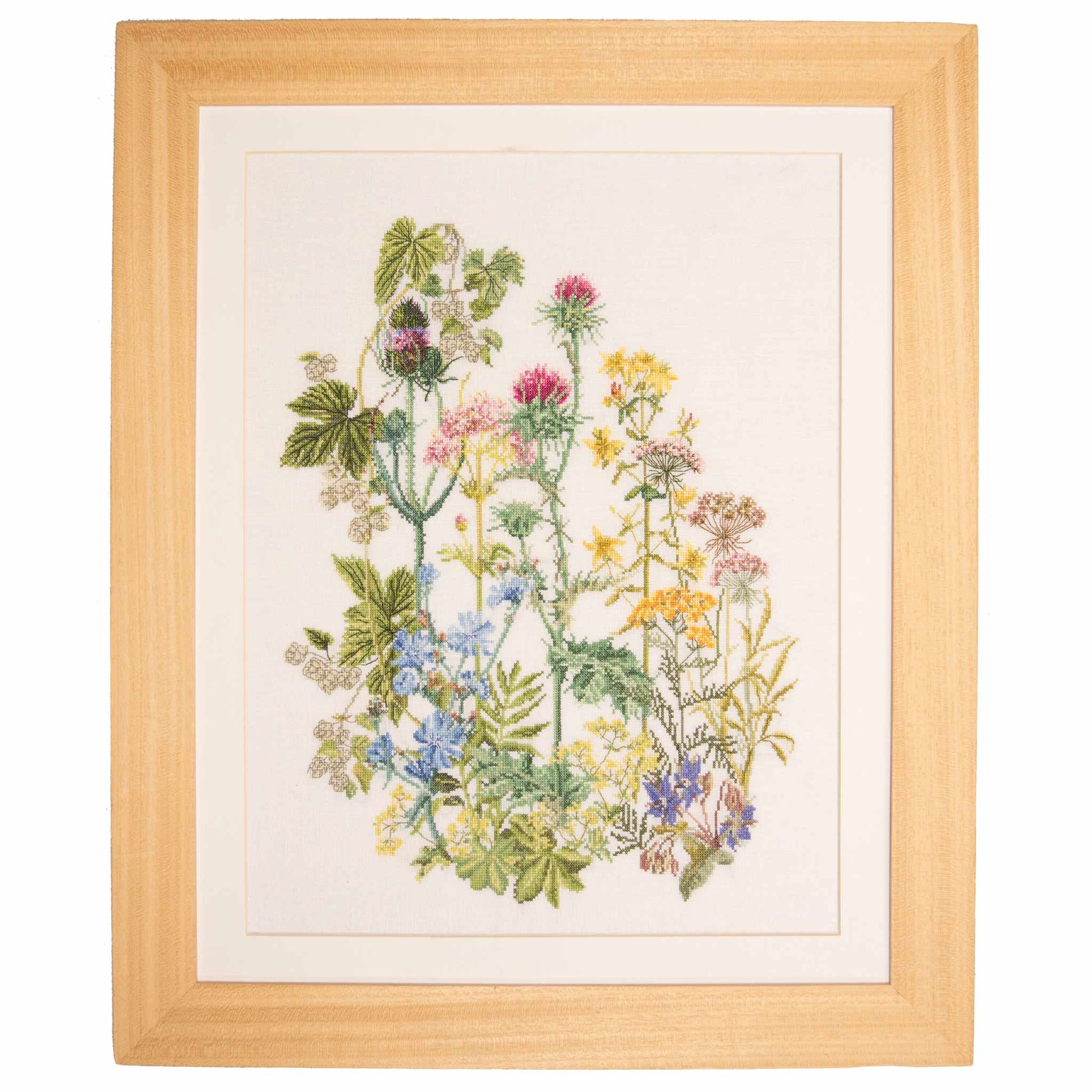 Framed cross stitch adesign of colorful wild flowers on a white background