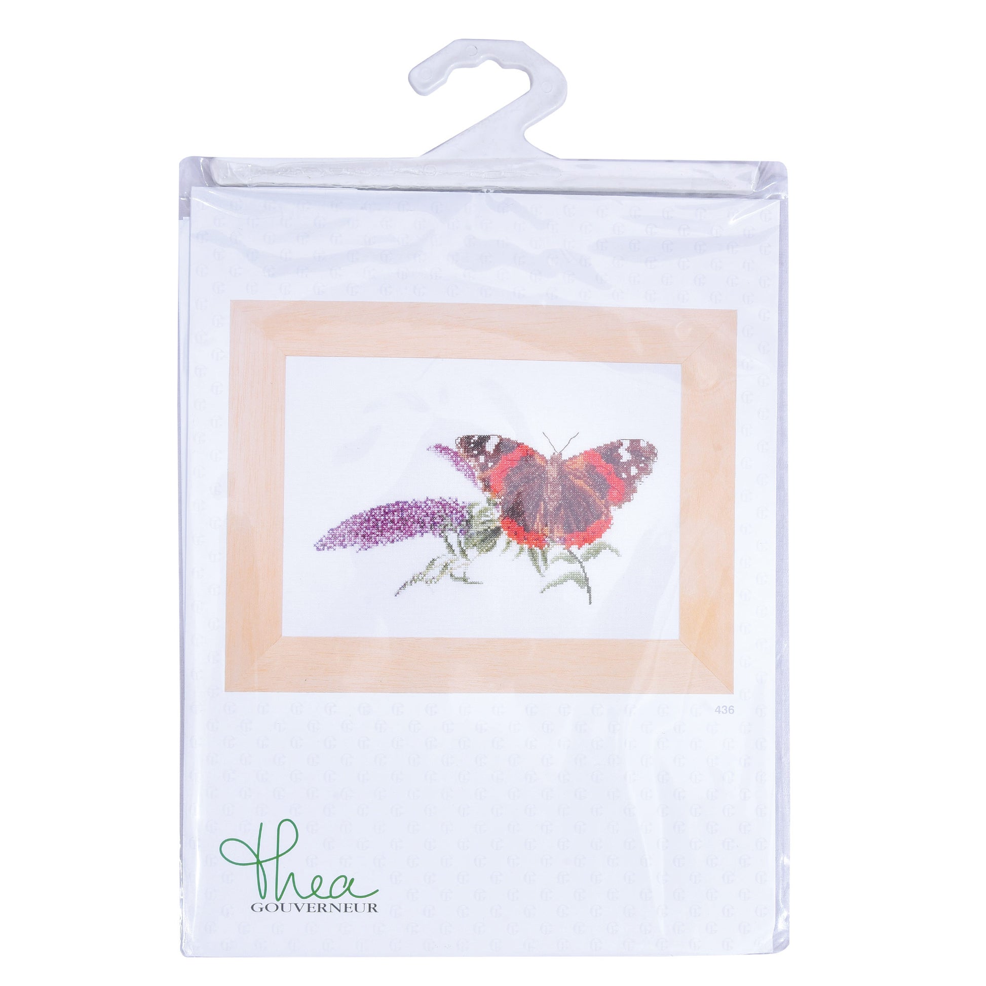 Embroidery design of a butterfly on a flower with 'Thea Gouverneur' branding, displayed in clear packaging.