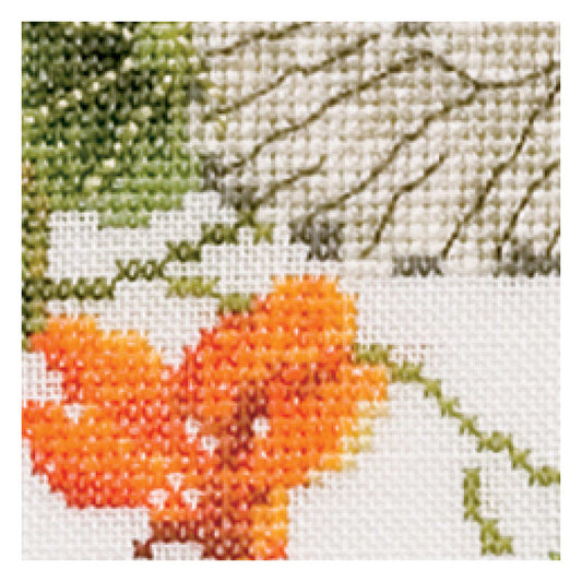 Cross-stitched orange flower with green leaves close up