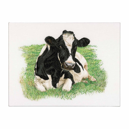 Black and white cow lying on grass cross stitch design