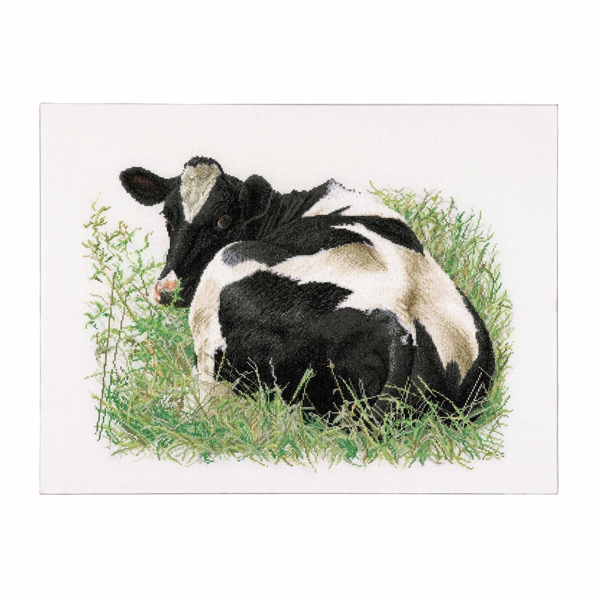 Black and white cow lying in grass cross stitch design