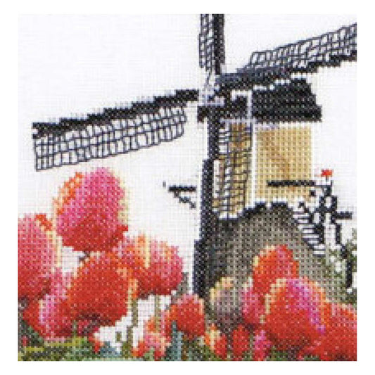 Cross-stitched design of a windmill with red tulips in the foreground