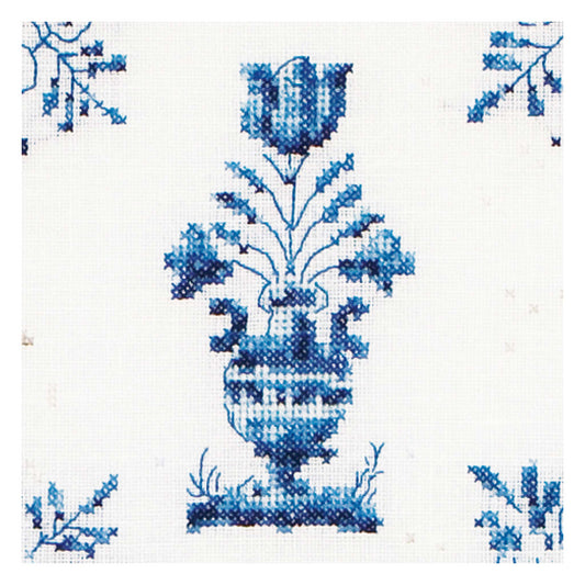 Blue floral design on white fabric, cross-stitching close up
