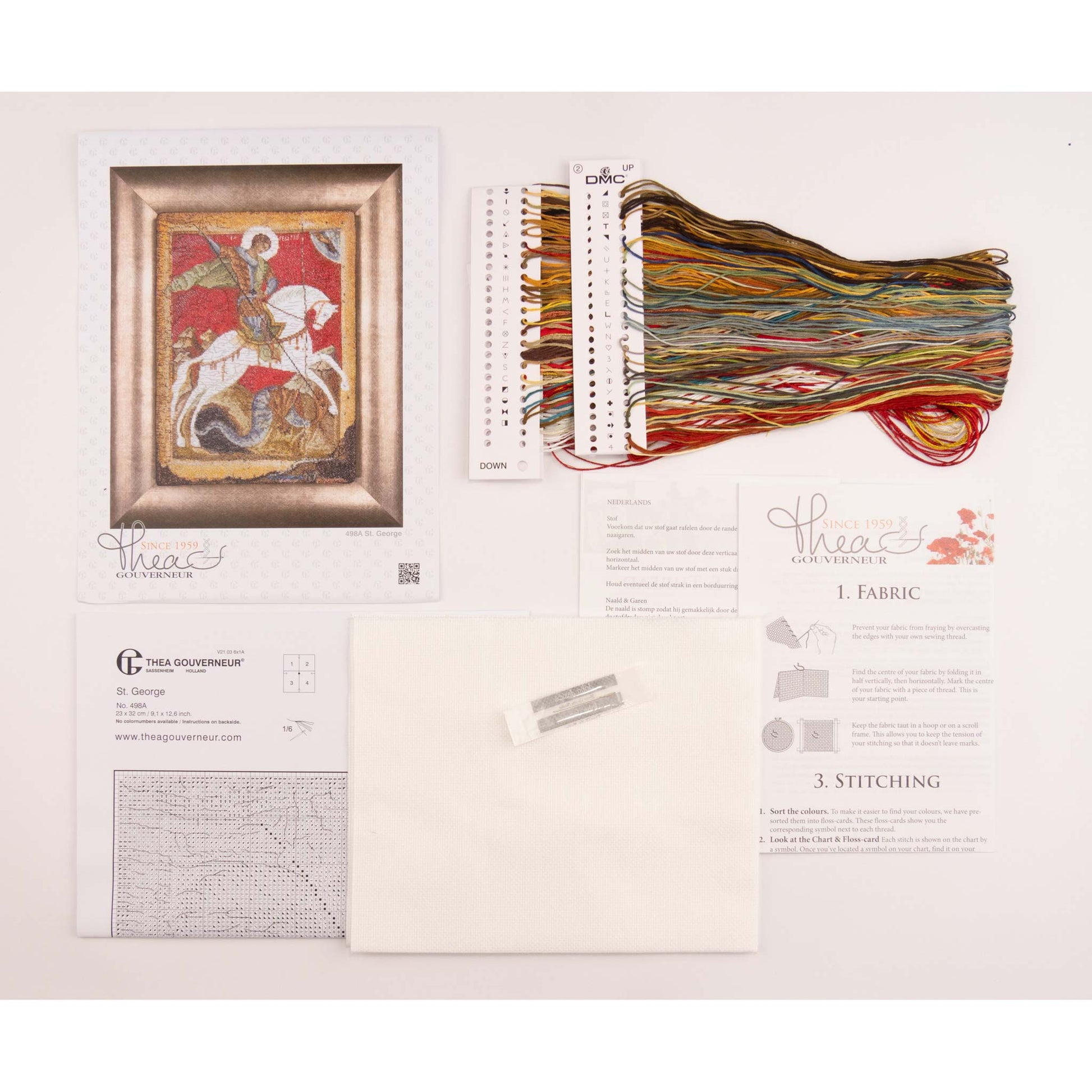 Embroidery kit with fabric, threads, and pattern chart on a white background