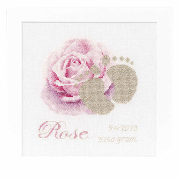 Decorative cross stitch with a pink rose and baby footprints on a white background