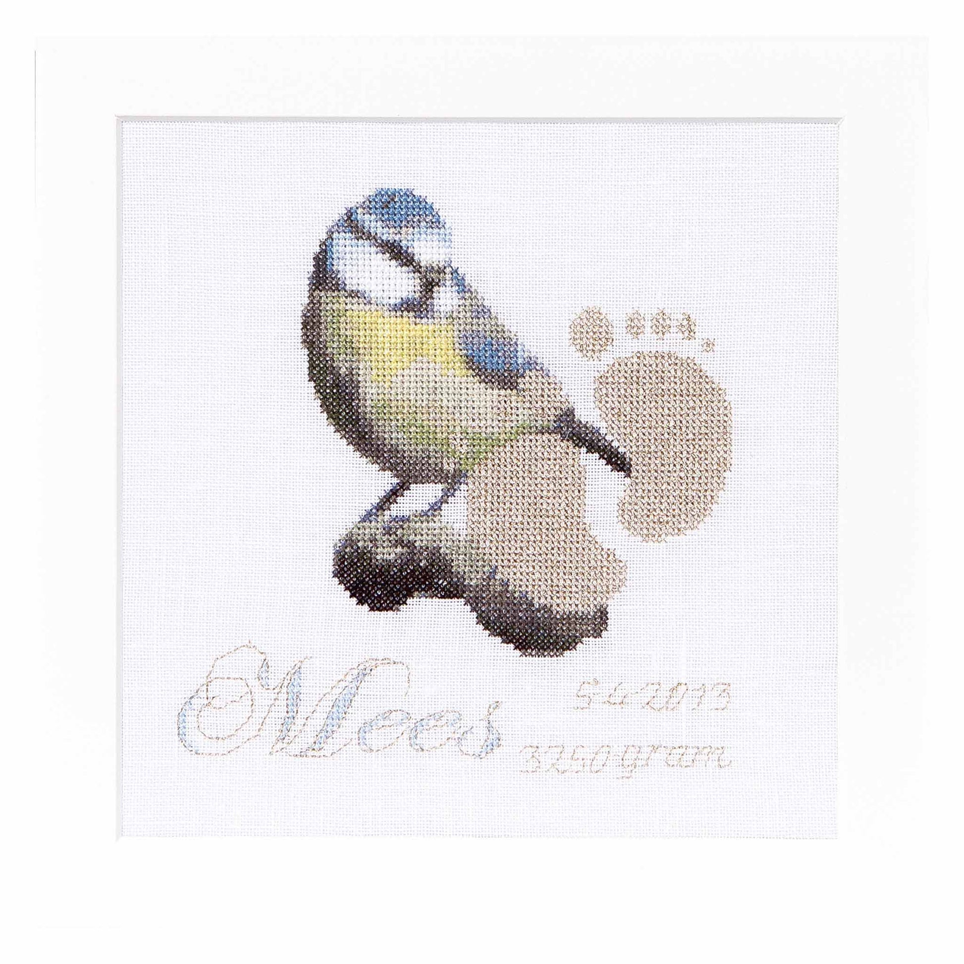 Cross-stitched design of a bird for newborn sample