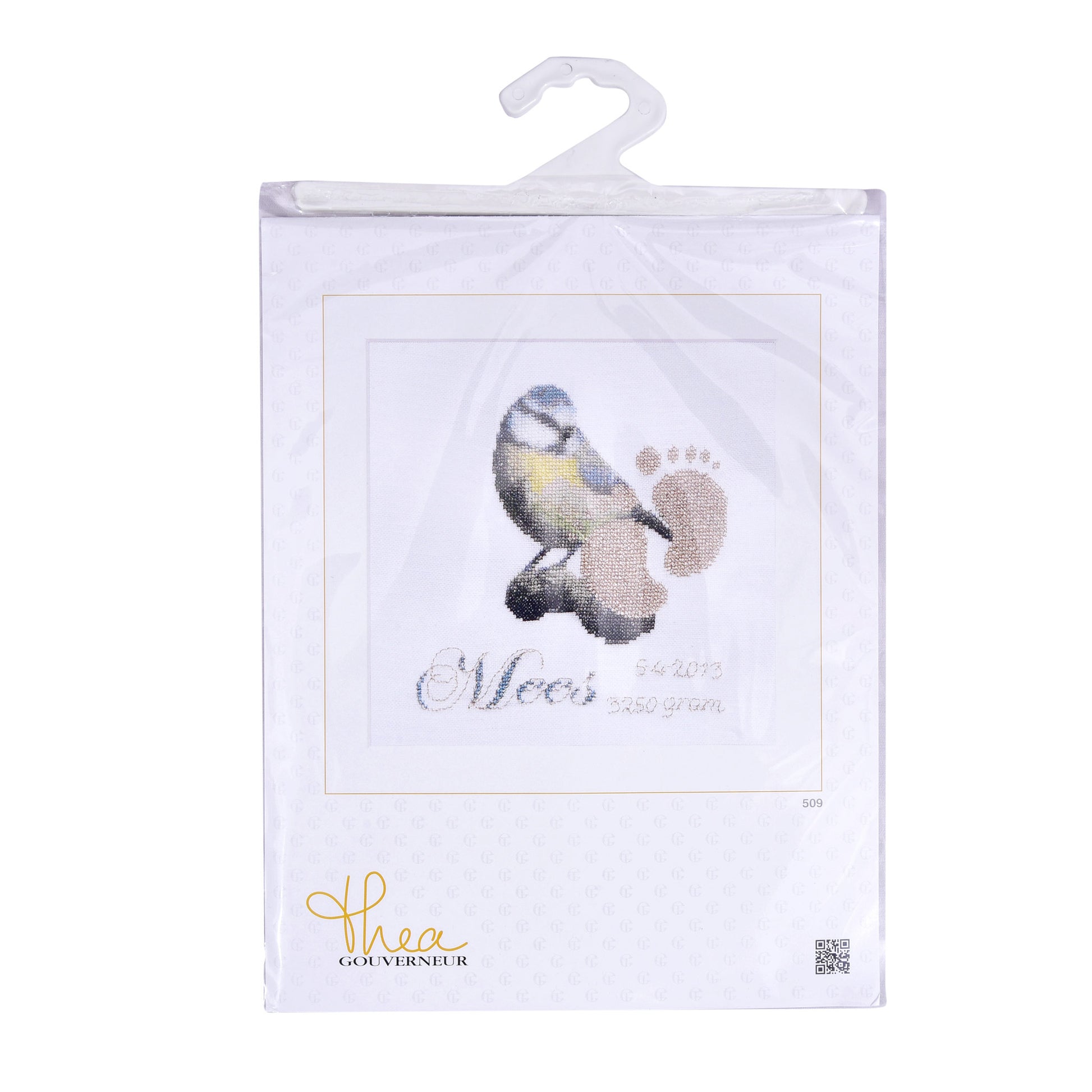 Packaged cross stitch kit birth sample with a bird illustration and text on a white background