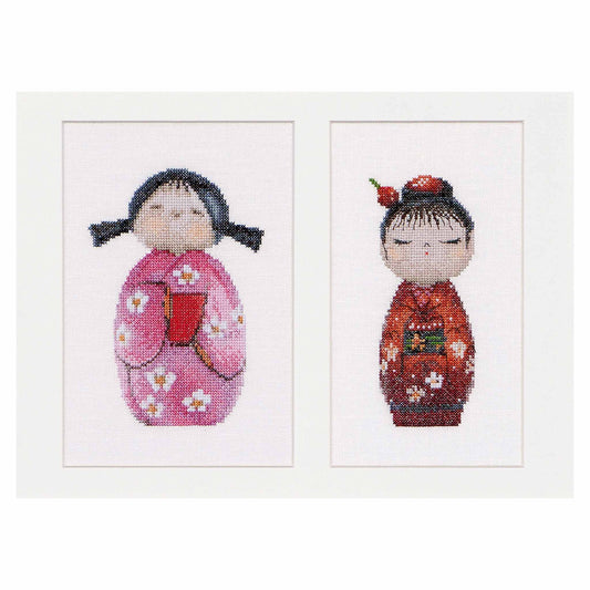 Two cross-stitched dolls in pink and red Kokeshi Dolls 