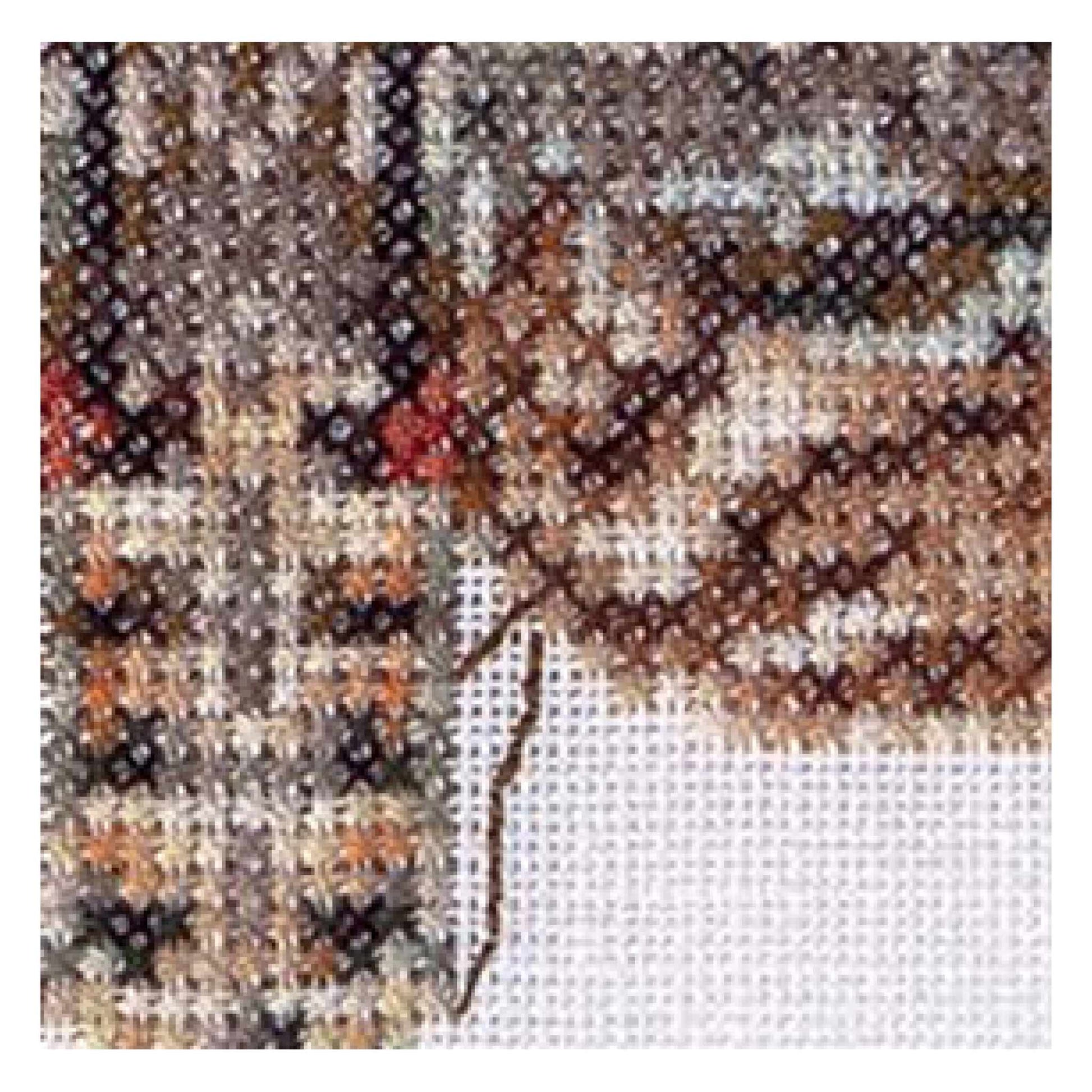 Close-up of a cross-stitched butterfly design on fabric