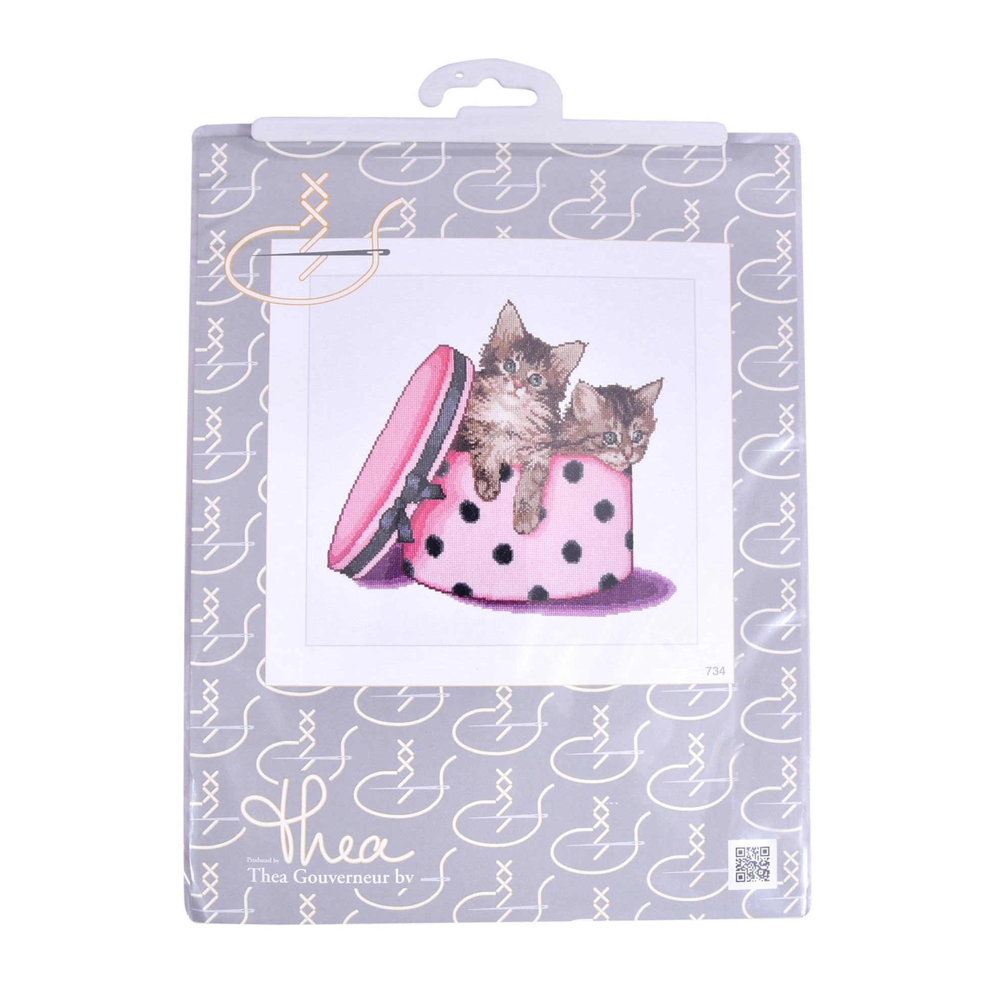 Packaged cross stitch kit with a design of two kittens in a pink polka dot hat, branded 'thea gouverneur'.