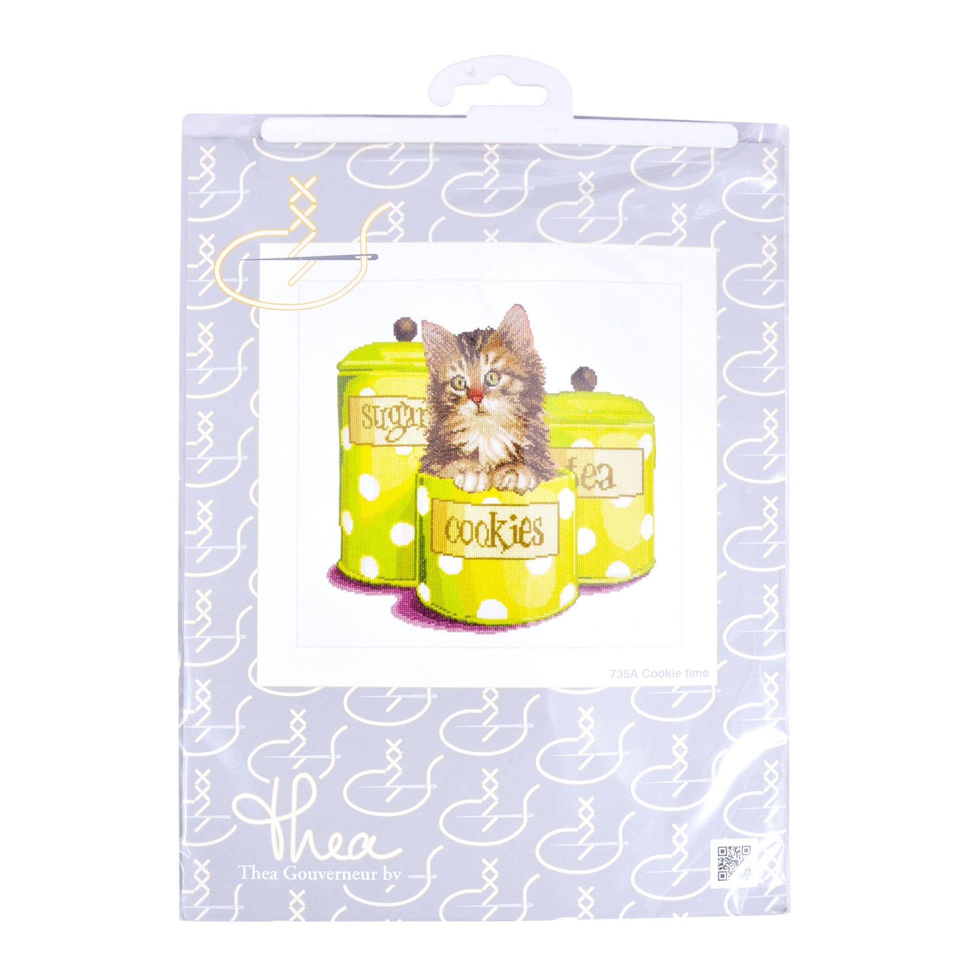 Packaging of cat-themed cookie jars with a kittencross stitch kit on a light purple background.