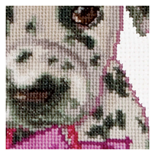 Close-up of a cross-stitched pattern with black, white, and pink colors on a beige fabric background.