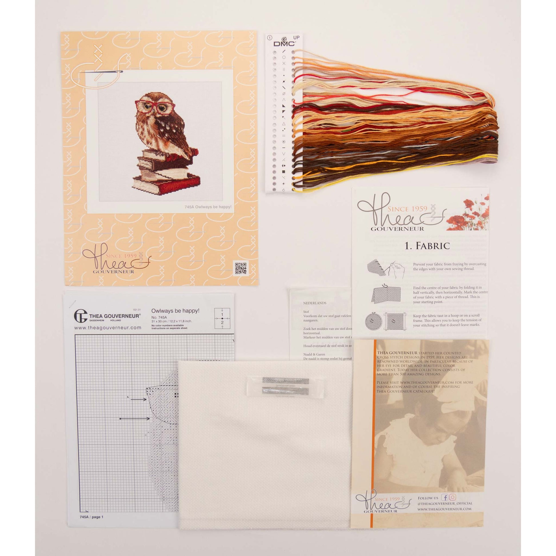 Embroidery kit with pattern and chart, needlework fabric, and threads on the floss organizer.