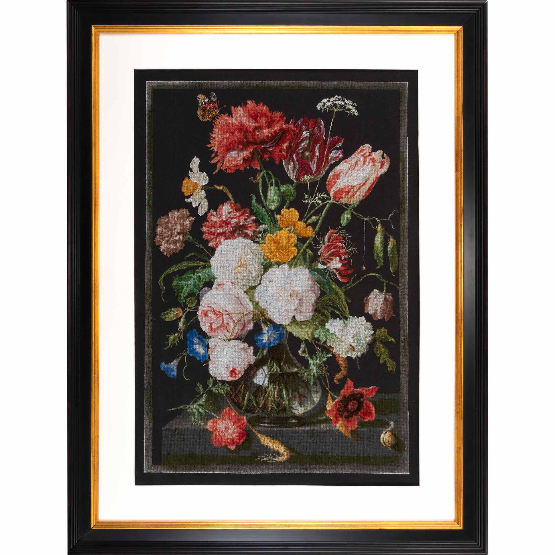 Framed cross stitchof a still life with flowers in a vase on a dark background