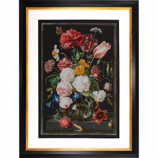 Framed cross stitchof a still life with flowers in a vase on a dark background
