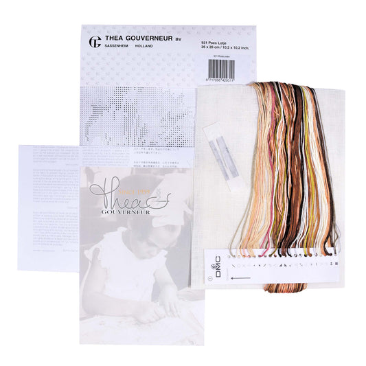 Embroidery kit with pattern and chart, needlework fabric, and threads on the floss organizer.