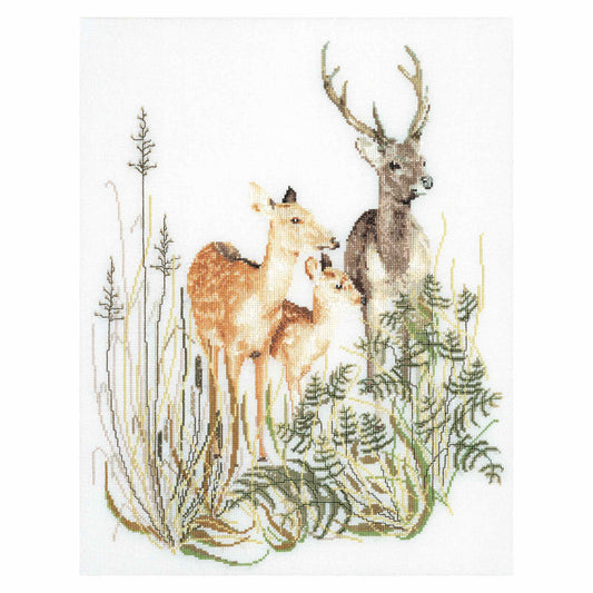 Deer family in a forest scene with trees and plants.