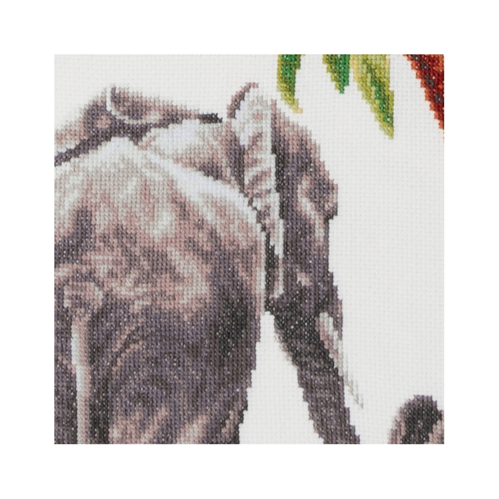 Close-up of a cross-stitched design featuring elephants with a colorful background.