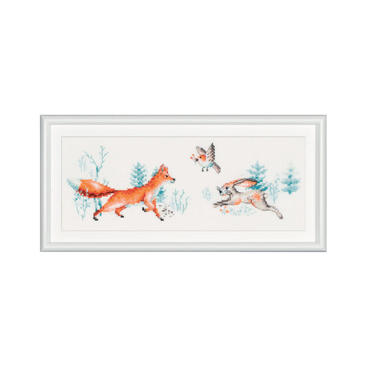 Framed cross-stitch pattern of foxes and birds in a forest setting on a white background