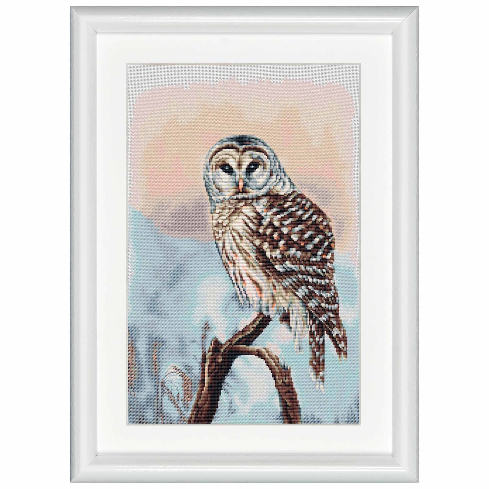 Cross-stitched owl on a branch with a snowy landscape in a white frame