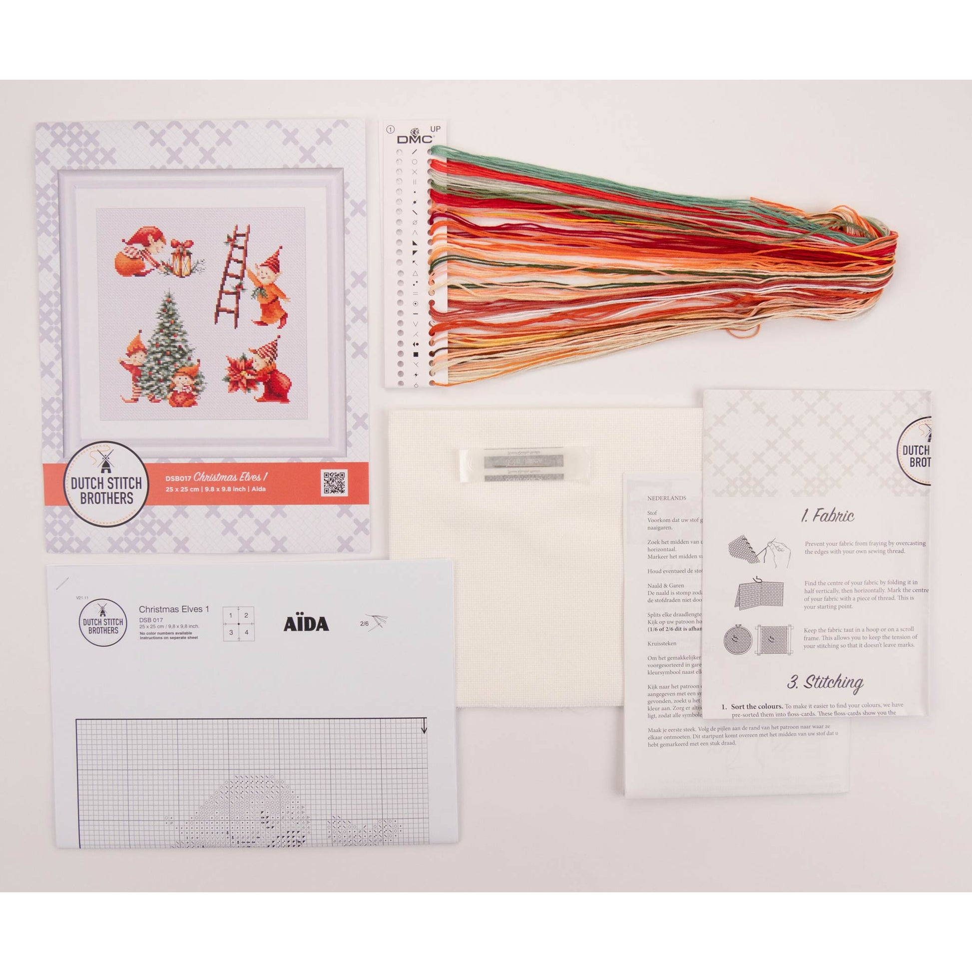 Embroidery kit with pattern and chart, needlework fabric, and threads on the floss organizer.