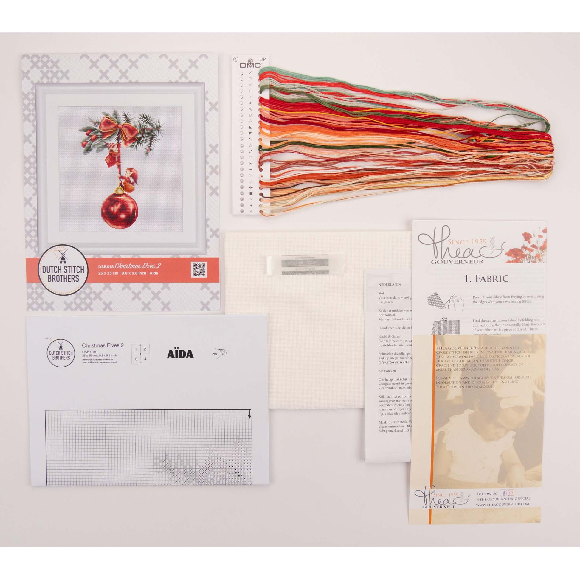 Embroidery kit with pattern and chart, needlework fabric, and threads on the floss organizer.