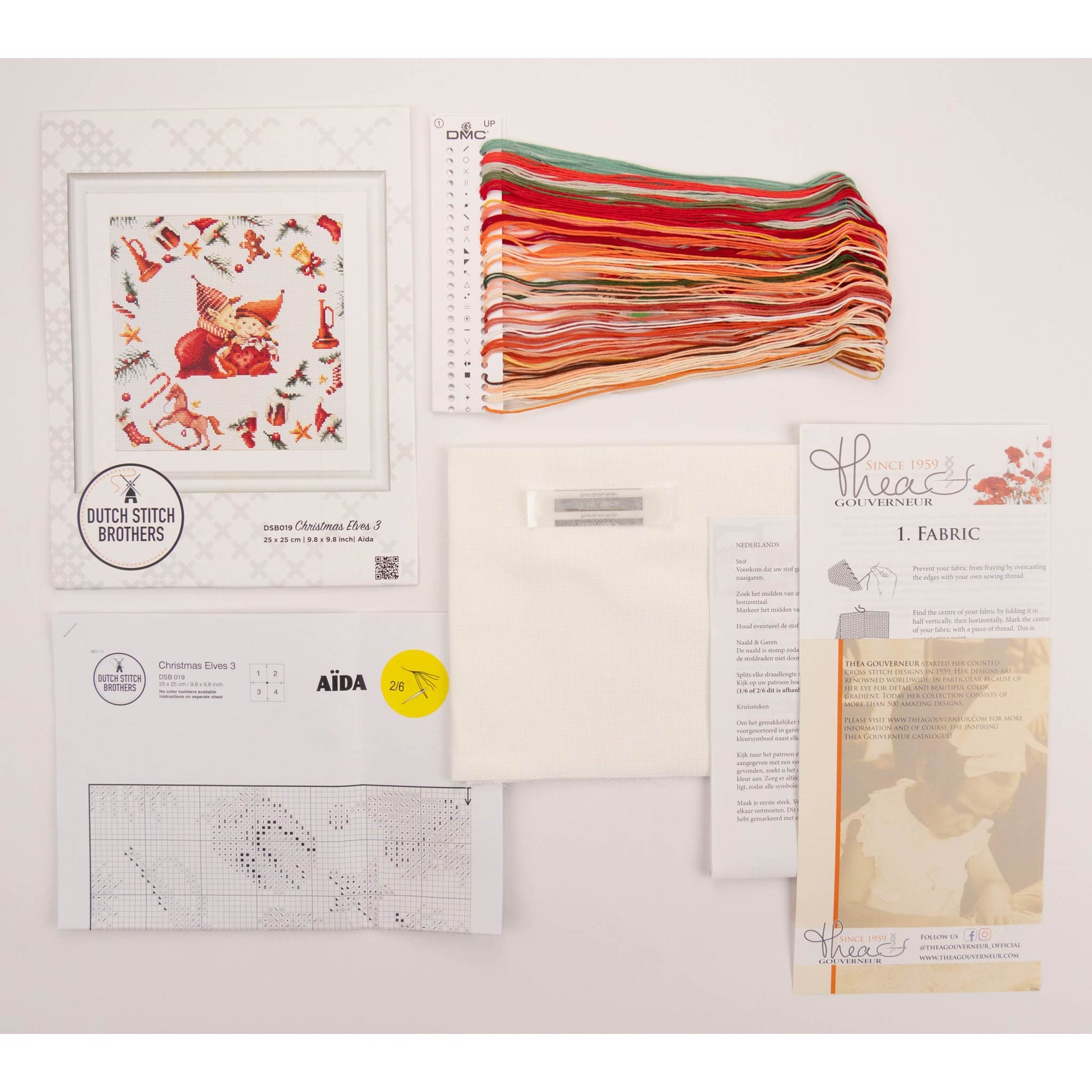 Cross stitch kit with embroidery hoop, presorted threads, and pattern chart on a white background
