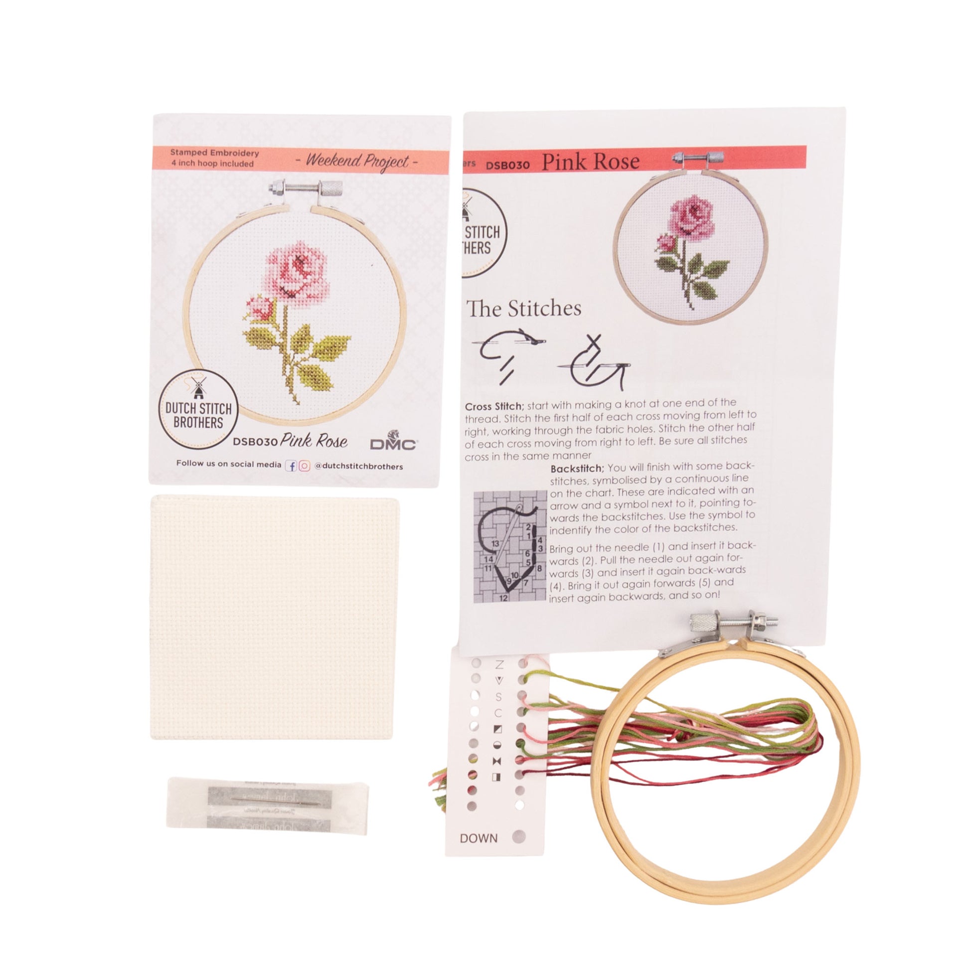Embroidery kit with pink rose design, thread, and hoop on a white background