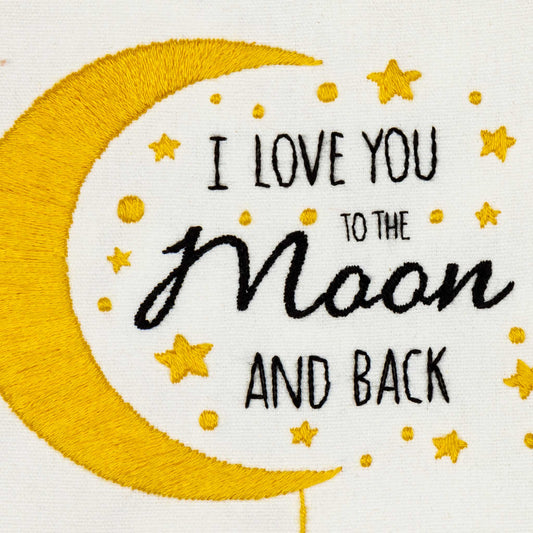 Embroidery design with 'I love you to the moon and back' text on a yellow crescent moon and white background.