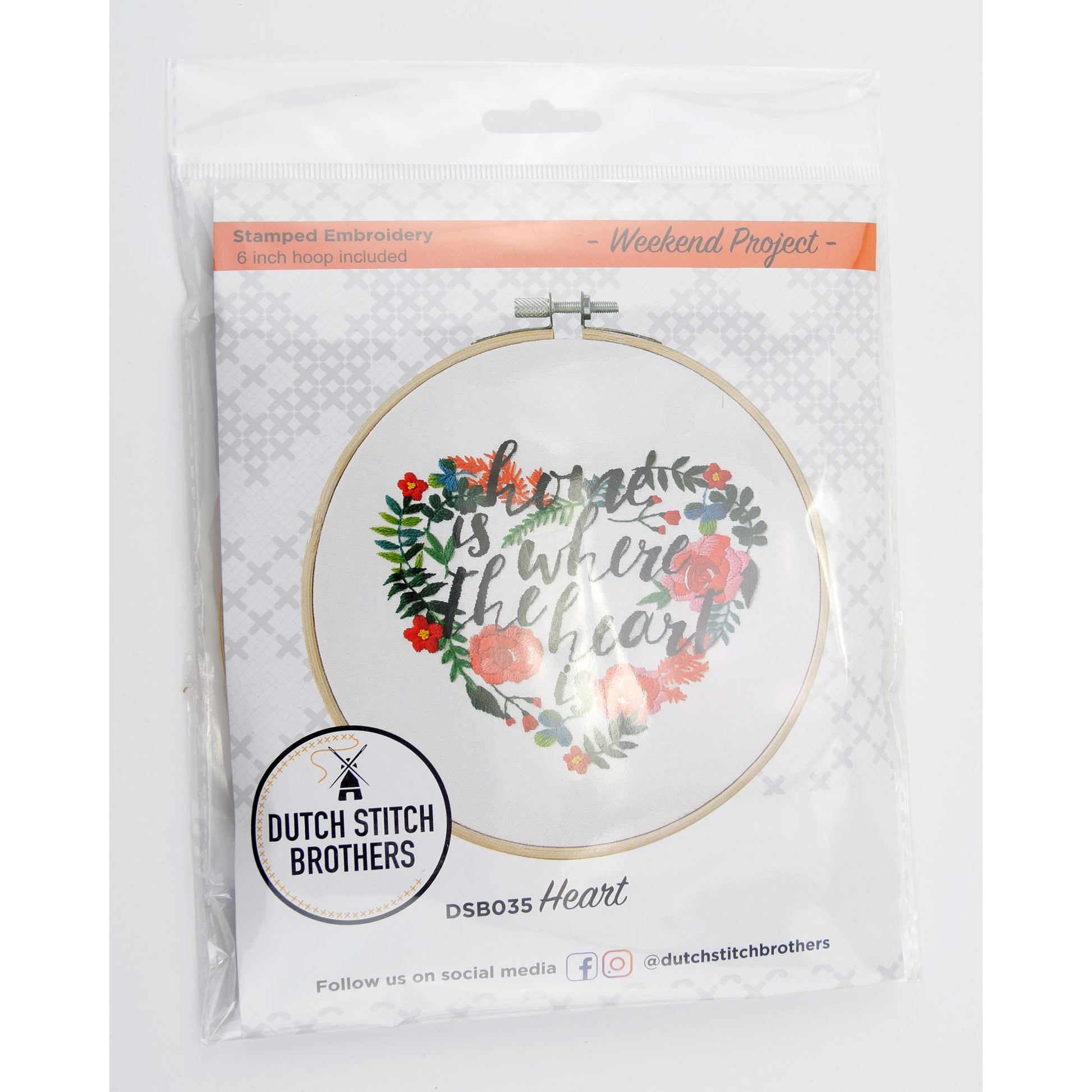 Embroidery hoop with floral design and text 'Happiness is where the heart is' in packaging, featuring Dutch Stitch Brothers branding.