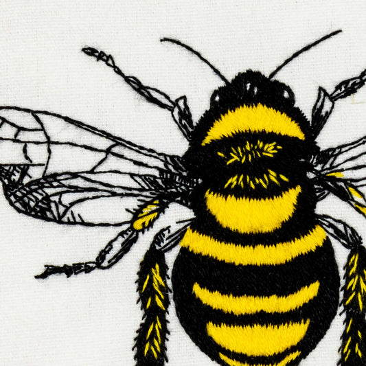 Embroidered bee with black and yellow stripes on a white background