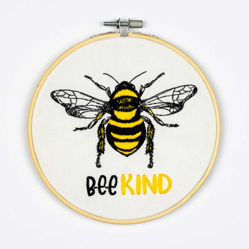 Embroidery design on thehoop with a bee and 'Bee Kind' text on a white background