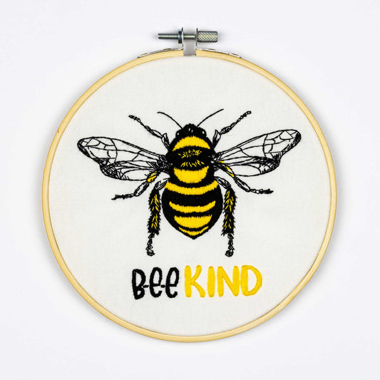 Embroidery design on thehoop with a bee and 'Bee Kind' text on a white background