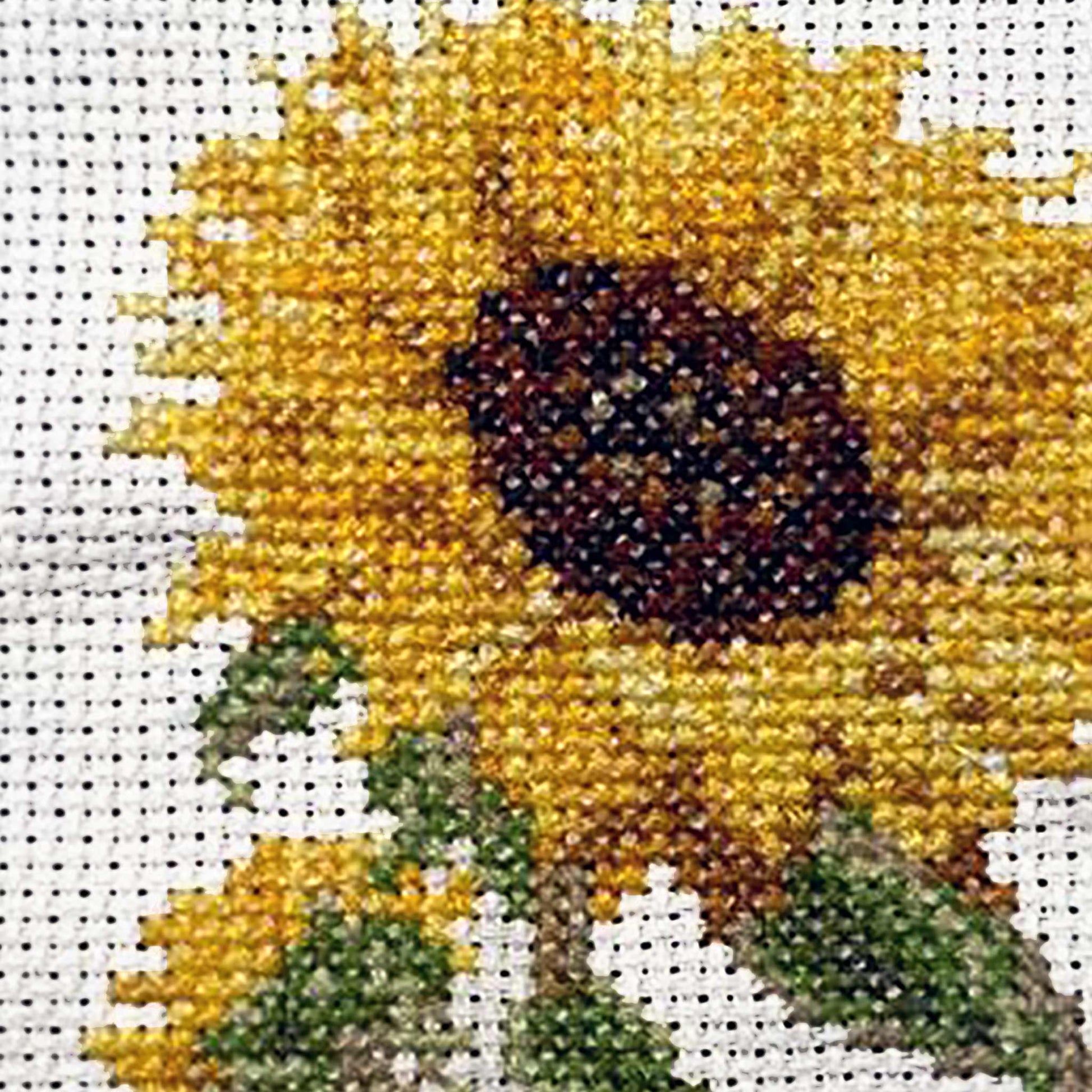 Cross-stitched sunflower on a white background