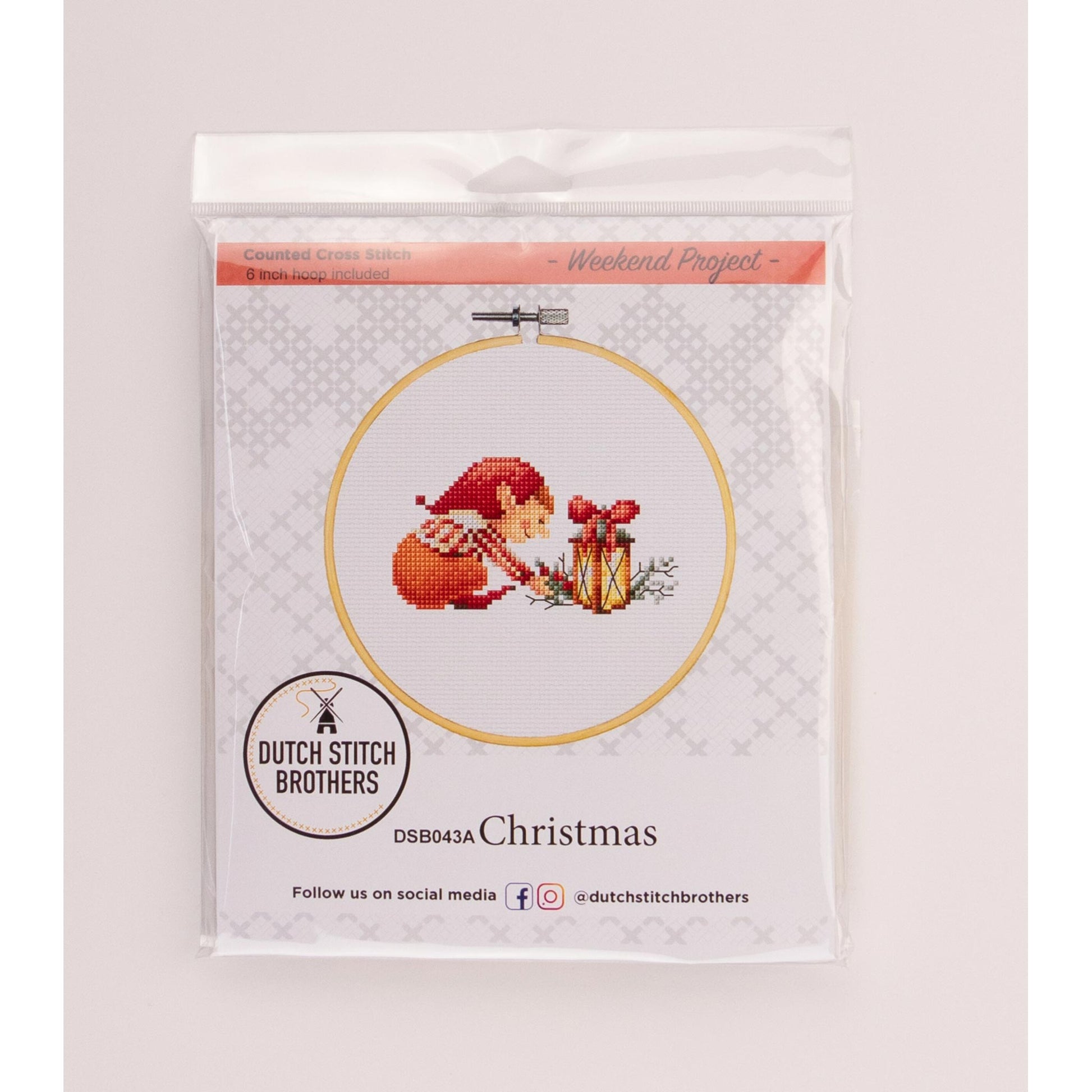 Cross-stitch kit packaging with a Christmas elf design Dutch Stitch Brothers brand