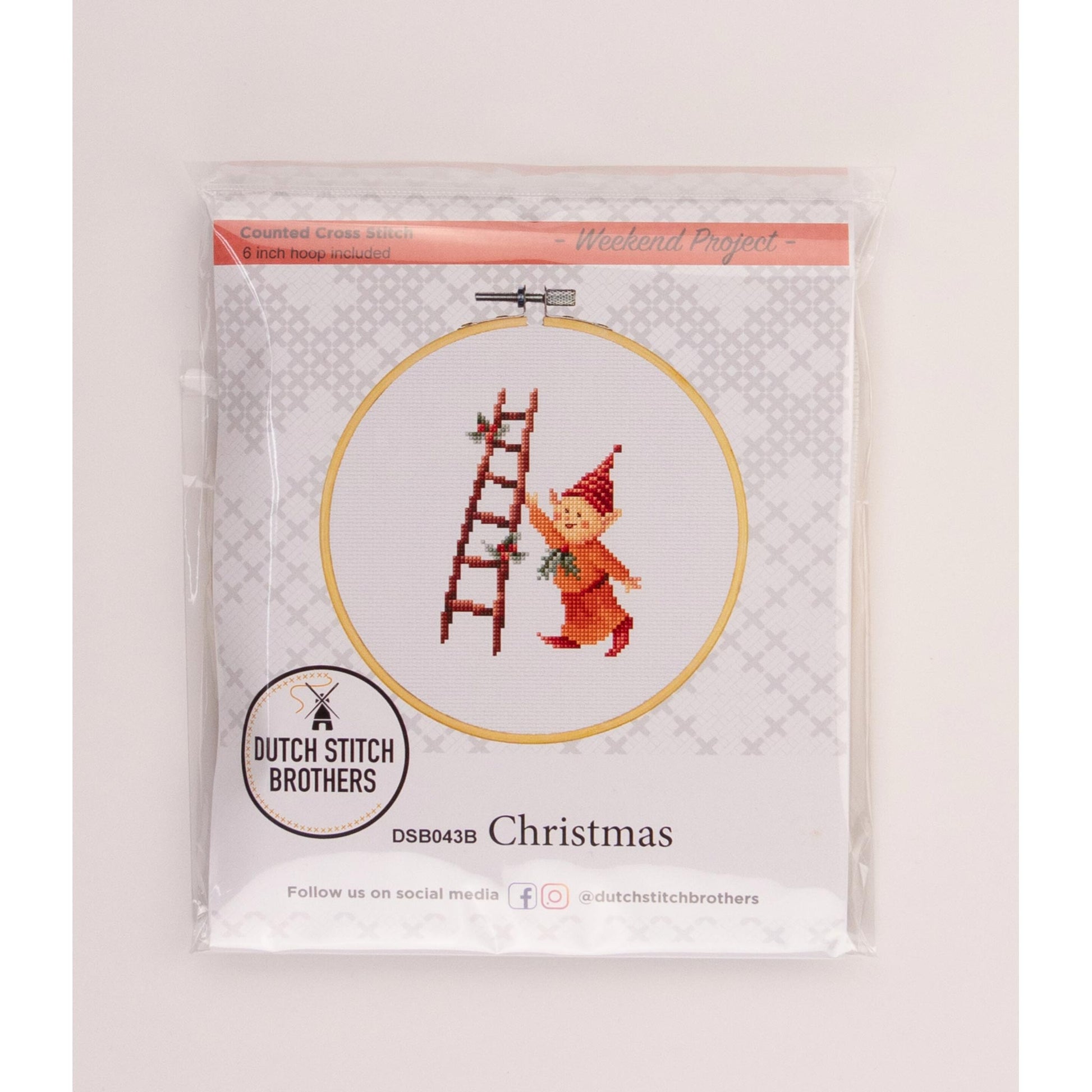 Cross-stitch kit with a Christmas design featuring an elf and ladder, branded 'Dutch Stitch Brothers'.